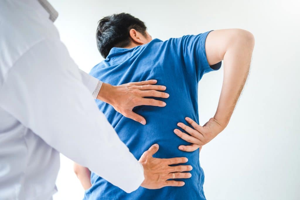 Doctor examines patient’s back