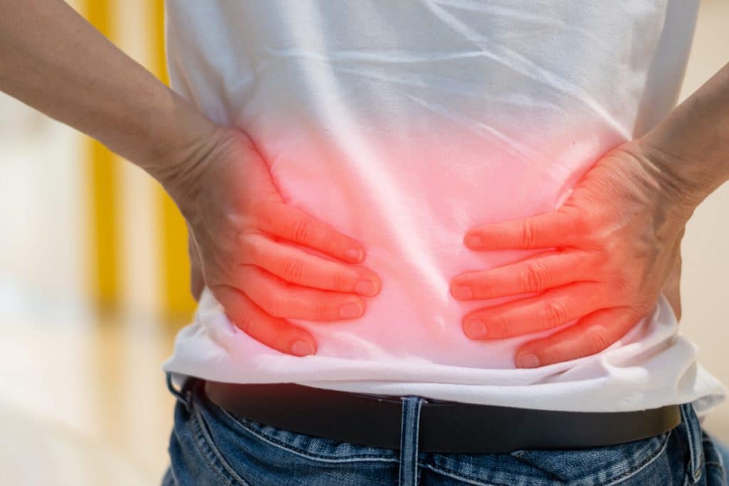 Man’s hands on back, highlighted by red