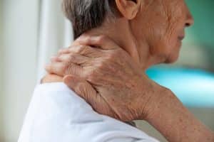 Close-up view of person experiencing neck pain