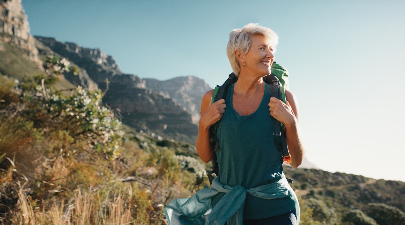 Mature person hiking in forest at peace