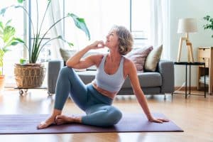 Senior person doing yoga at home