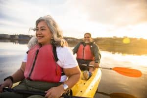 Senior couple kayaking on lake